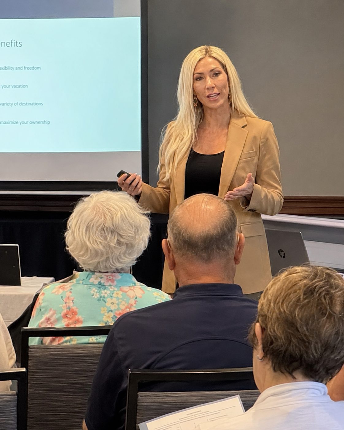 A presenter leading a live timeshare education seminar for owners